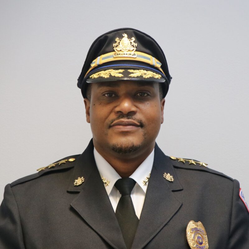 Photo of a man in a police uniform with gold stars on the shoulders